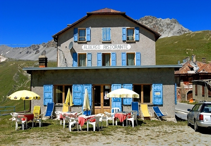 Italy An empty, faded Albergo restaurant near the top of the Stelvio Pass with parasols and tables outside, but no guests, South Tyrol, Italy, Europe, by Dirk v. Mallinckrodt