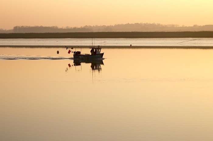 United Kingdom Small fishing boat at sunset in winter on the River Deben, Ramsholt, Suffolk, England, UK, by Ian Murray