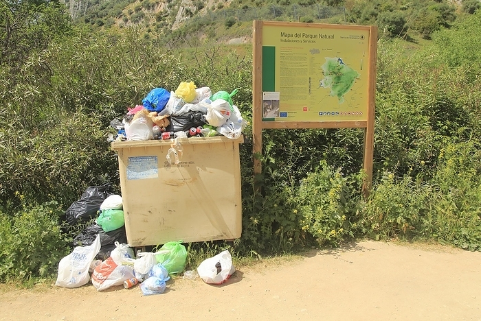 Spain Overflowing rubbish bin at natural park, Cueva del Gato, Benaojan, Serrania de Ronda, Malaga province, Spain, Europe, by Ian Murray