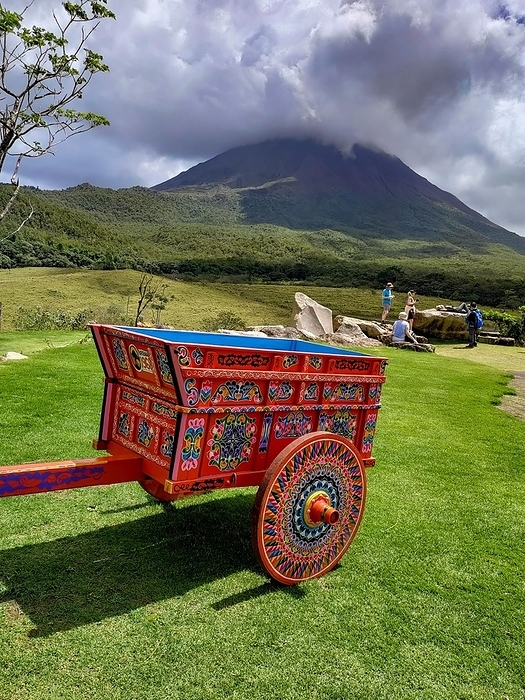 Costa Rica Arenal Volcano National Park, Costa Rica, A painted Costa Rican oxcart  carreta  below the Arenal volcano. The oxcart is important in Costa Rican history, used to transport coffee and other products. Today the oxcart is one of the countrys national symbols, Central America, by Jim West