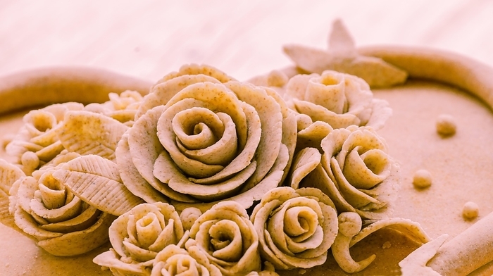 Closeup of rose patterns beige dough sculpture, Teig, gebacken, by John Erskin