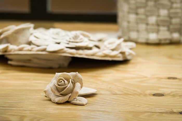 Closeup of rose patterns beige dough sculpture, Teig, gebacken, by John Erskin