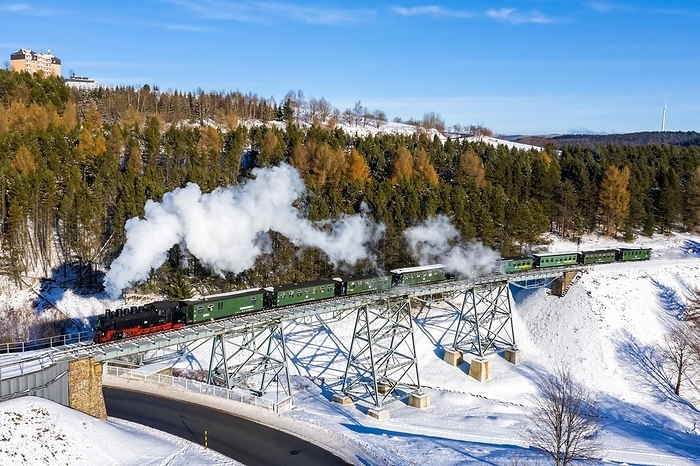 Germany Steam train of the Fichtelbergbahn railway Steam locomotive on a bridge in winter Aerial view in Oberwiesenthal, Germany, Europe, by Markus Mainka