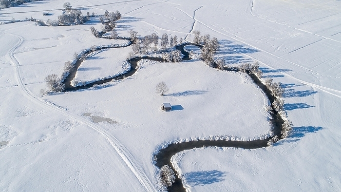 Germany Drone shot of the river Schmutter meandering naturally through the snowy winter landscape of the Western Forests nature park Park near Augsburg, Swabia, Bavaria, Germany, Europe, by alimdi   Reinhold Ratzer