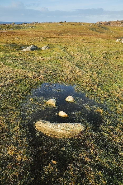 Scotland Natural smiley made of stones in the middle of a puddle of water in a meadow in the Highlands of Scotland, by Patrick Frischknecht