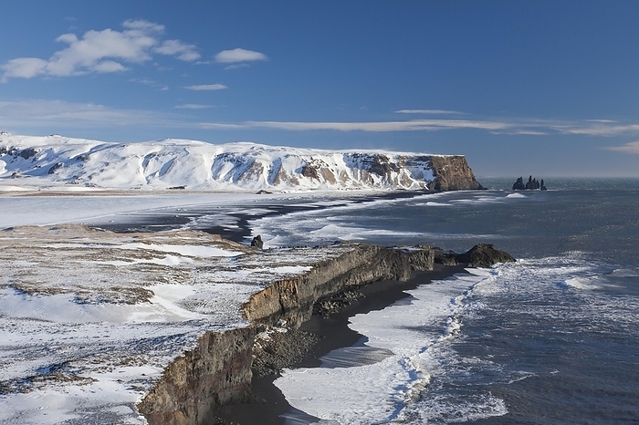 Iceland Reynisdrangar, basalt sea stacks in the snow in winter near the village V k   M rdal, southern Iceland, by alimdi   Arterra