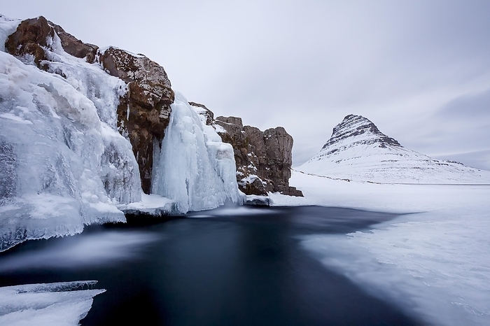 Iceland Kirkjufell mountain and the frozen waterfall Kirkjufellsfoss on the Sn fellsnes peninsula in the snow in winter, Iceland, Europe, by alimdi   Arterra