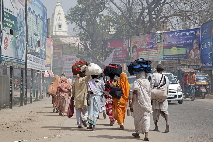 India Indian pelgrims carrying luggage on their heads while walking to the Holi festival in Vrindavan, Uttar Pradesh, India, Asia, by alimdi   Arterra   Marica van der Meer