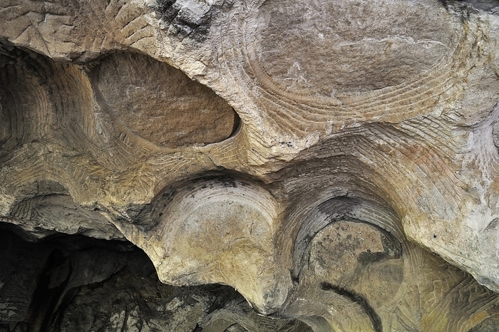 Luxembourg Grooves and circles in the sandstone rock from carving millstones at the Hohllay cave in Berdorf, Little Switzerland, Mullerthal, Grand Duchy of Luxembourg, by alimdi   Arterra   Philippe Cl ment