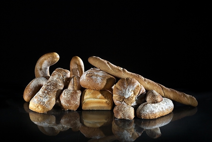 Assortment of different loaves of bread on black background, by alimdi / Arterra / Johan De Meester