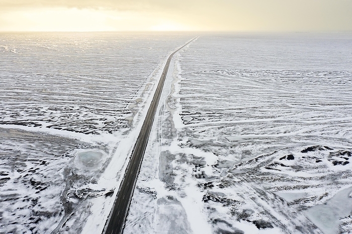 Iceland Aerial view over Route 1, Ring Road, two lane national road in desolate snow covered winter landscape, Su urland, Southern Region, South Iceland, by alimdi   Arterra   Sven Erik Arndt