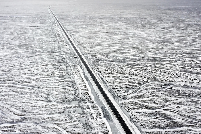 Iceland Aerial view over Route 1, Ring Road, two lane national road in desolate snow covered winter landscape, Su urland, Southern Region, South Iceland, by alimdi   Arterra   Sven Erik Arndt