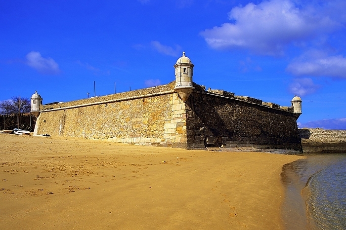 Golden sand on the beach at Lagos, with the old harbour defenses, the 17th century Forte Bandeira, under a deep blue sky, Algarve, Portugal, Europe, by Klaus Steinkamp