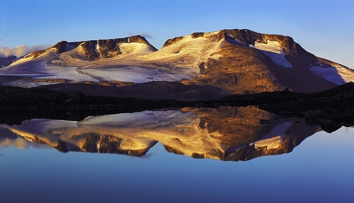 Norway Early morning light on the Fannaraken peaks with a mirror like reflection in a glacial lake, Jotunheim region, Norway, Europe, by Klaus Steinkamp