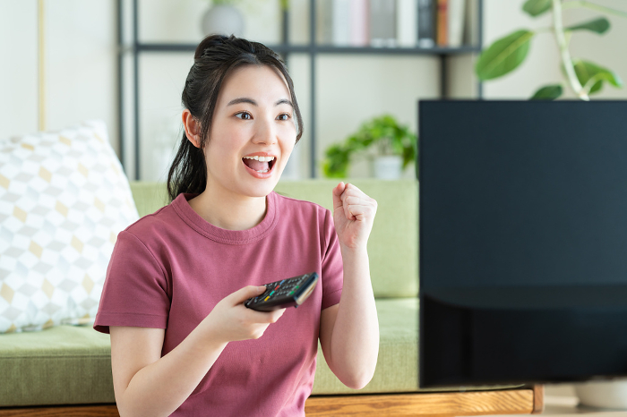 Young Japanese woman watching TV (People)