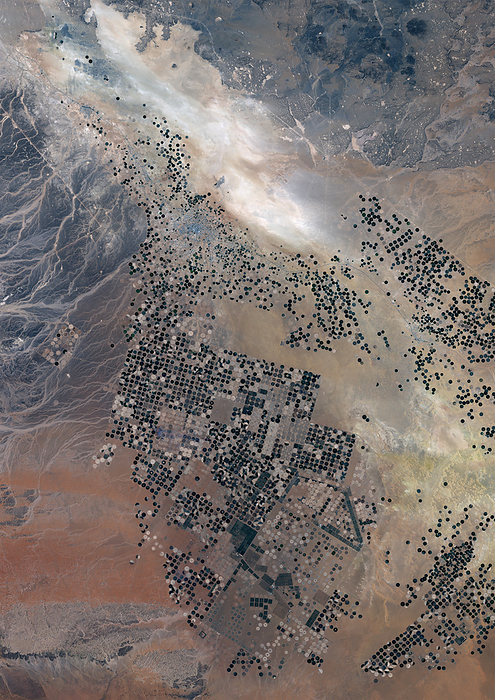 Agricultural Fields in Wadi As Sirhan Basin, Saudi Arabia in 2022 Color satellite image of agricultural fields in the Wadi As Sirhan Basin, Saudi Arabia in 2022. That water is distributed in rotation about a center point within a circular field a technique known as center pivot agriculture. by Planet Observer Universal Images Group