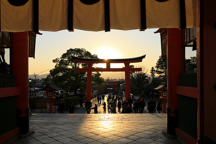 Torii gate and sunset over the gate of Fushimi Inari-taisha shrine, Kyoto