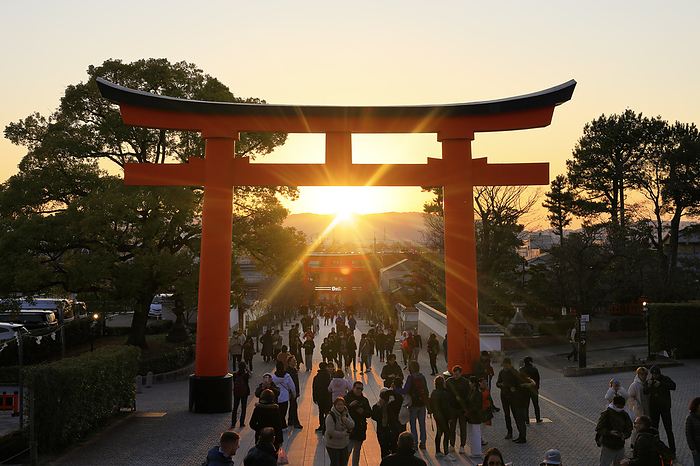 Torii gate and sunset at the front approach to Fushimi Inari-taisha shrine, Kyoto, Japan