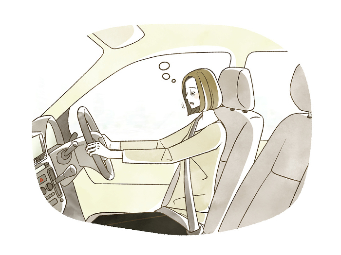 Woman falling asleep at the wheel of a car