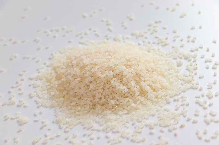 Many grains of rice on a white table