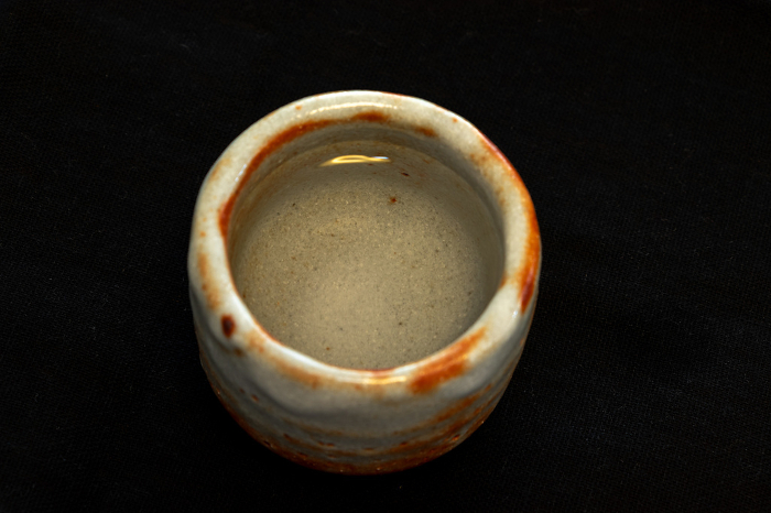 A boar cup with sake poured into it