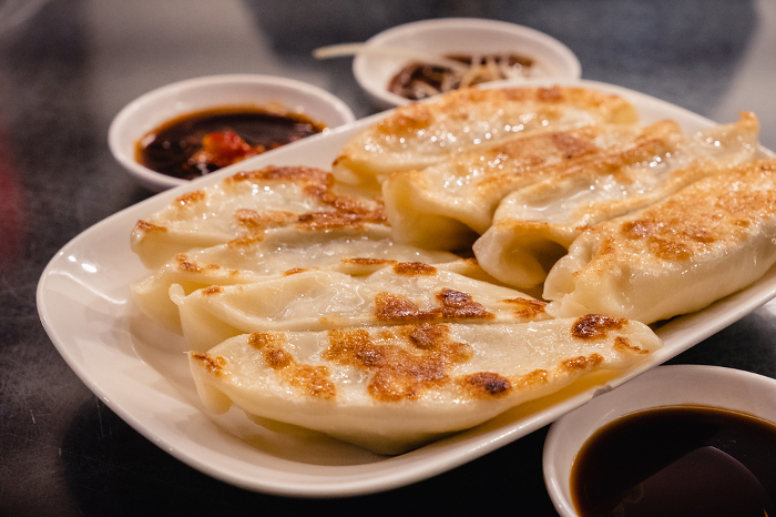 gyoza (crescent-shaped pan-fried dumplings stuffed with minced pork and vegetables)