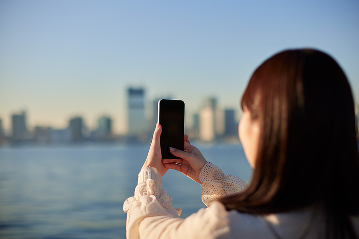 Japanese woman taking a photo with her smartphone