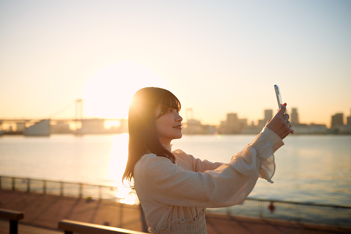 Japanese woman taking a photo with her smartphone
