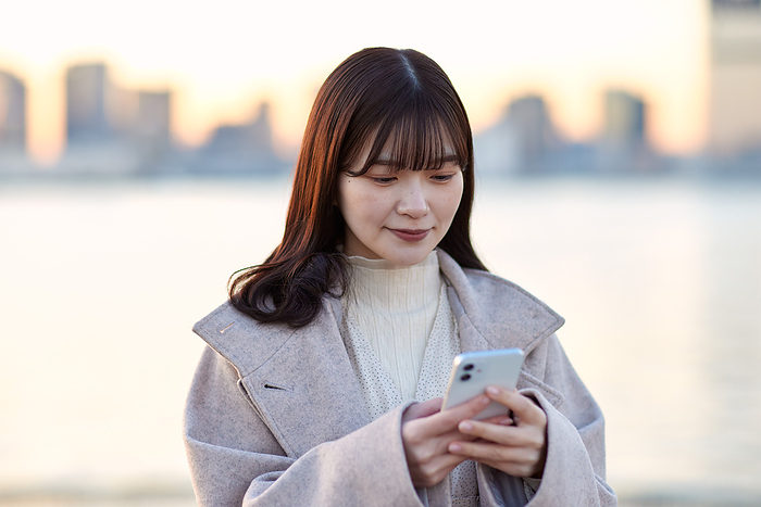 Japanese woman operating a smartphone