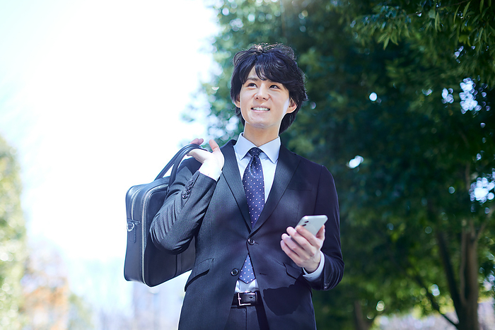 Japanese man holding a cell phone