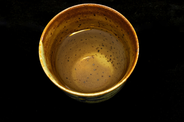 Ceramic cup with sake poured into it