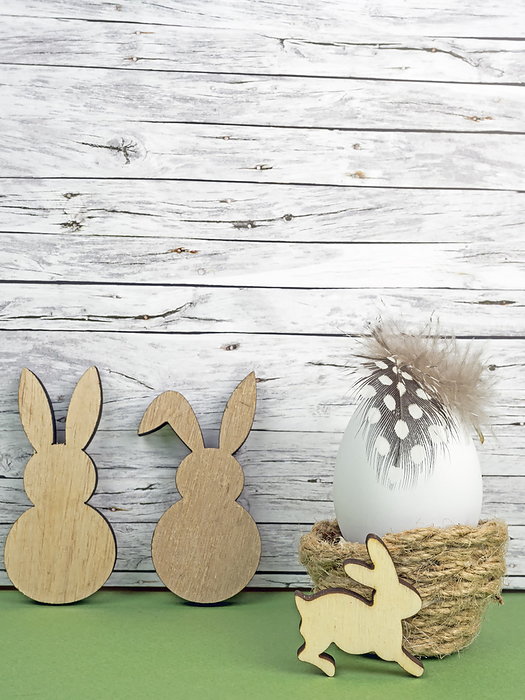 Easter background with Easter egg and Easter bunnies  isolated on green in front of wood Easter background with Easter egg and Easter bunnies  isolated on green in front of wood, by Zoonar Katrin May