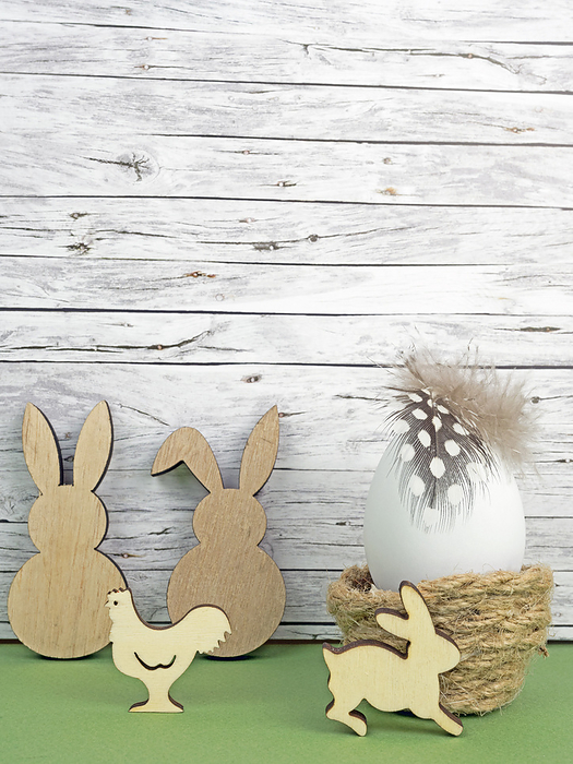 Easter background with Easter egg, Easter bunnies  and cock isolated on green in front of wood Easter background with Easter egg, Easter bunnies  and cock isolated on green in front of wood, by Zoonar Katrin May