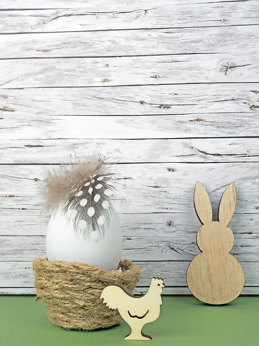Easter background with Easter egg, Easter bunny  and cock isolated on green in front of wood Easter background with Easter egg, Easter bunny  and cock isolated on green in front of wood, by Zoonar Katrin May