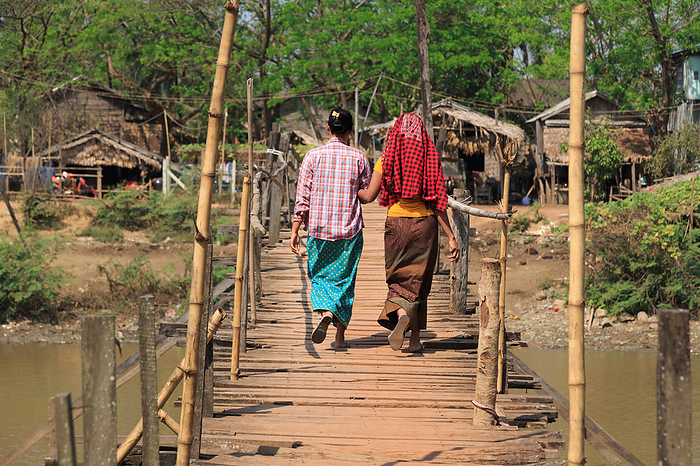 two women on a wooden bridge in Myanmar two women on a wooden bridge in Myanmar, by Zoonar Andreas Edelm