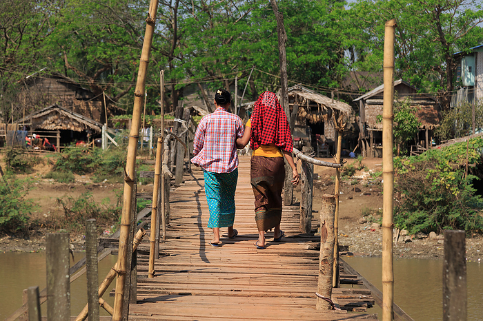 two women on a wooden bridge in Myanmar two women on a wooden bridge in Myanmar, by Zoonar Andreas Edelm