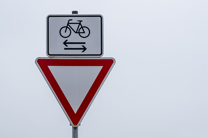 Pay attention to traffic sign right of way and bicycle riders from left and right Pay attention to traffic sign right of way and bicycle riders from left and right, by Zoonar AnnaReinert