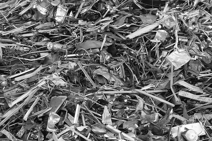 Scrap iron in a scrap yard, black and white Scrap iron in a scrap yard, black and white, by Zoonar Harald Biebel