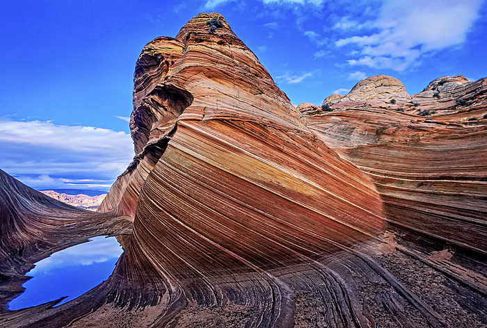 NA Spectacular formation of vibrant colors in swirls of fragile sandstone is known as The Wave and is located in the Coyote Buttes section of Vermilion Cliffs National Monument. An unmarked wilderness trail limits hikers and requires a permit from the Bureau of Land Management  Arizona, United States of America, by Melissa Farlow   Design Pics
