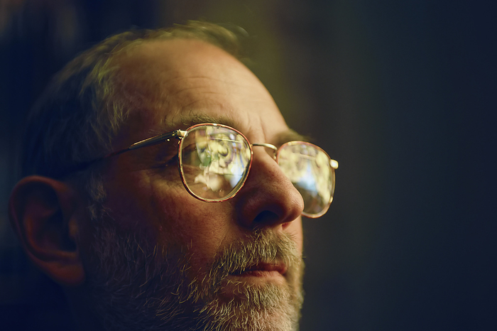 JOSAR_GENE_BEDIEUT Man in glasses with stained glass windows reflected in them  Lincoln, Nebraska, United States of America, by Joel Sartore Photography   Design Pics