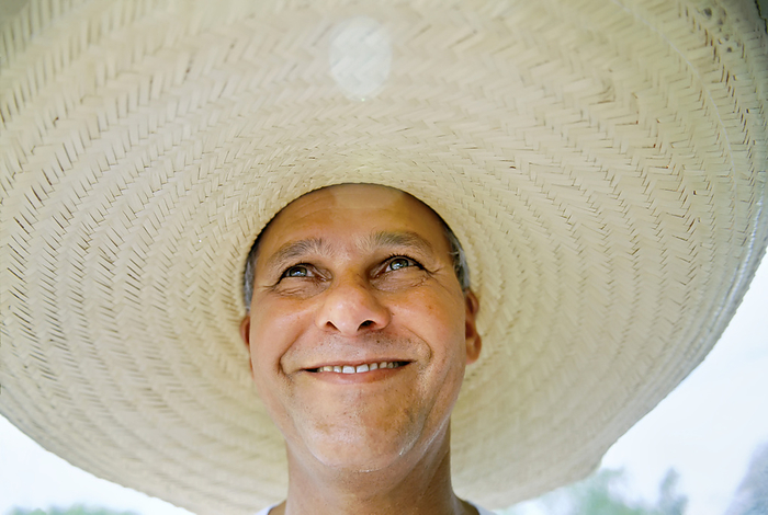 JOSAR_GIOVAH_P._ARUIS_FILIHO Brazilian man wearing a large brimmed hat  Pantanal Region, Brazil, by Joel Sartore Photography   Design Pics
