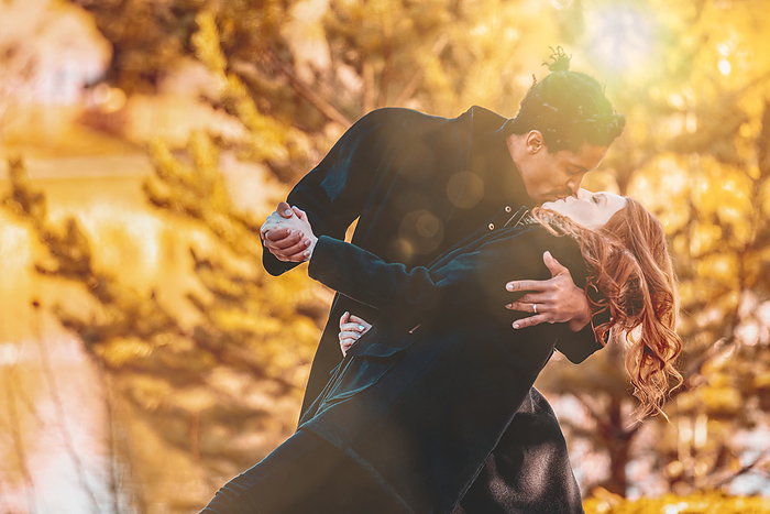 LJMZZ41642  Stevon Artis ,LJMZZ41643  Kayla Kimo  A mixed race couple kissing while dancing and spending quality time together during a fall family outing in a city park  Edmonton, Alberta, Canada, by LJM Photo   Design Pics
