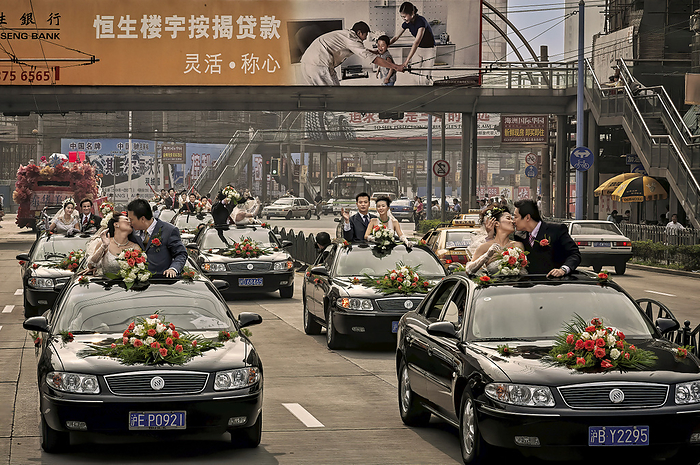 Shanghai, China Rose Wedding Festival couples in a motorcade to Century Park. Seventy couples participated in a mass marriage event that started at a shopping mall and ended up in Century Park for the ceremony  Shanghai, Jiangsu Province, People s Republic of China, by Randy Olson   Design Pics