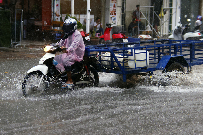 Season Monsoon. Heavy rain and water logging on road. Heavy rain and water logging on road during Monsoon season, Phnom Penh, Cambodia, Indochina, Southeast Asia, Asia, by Godong