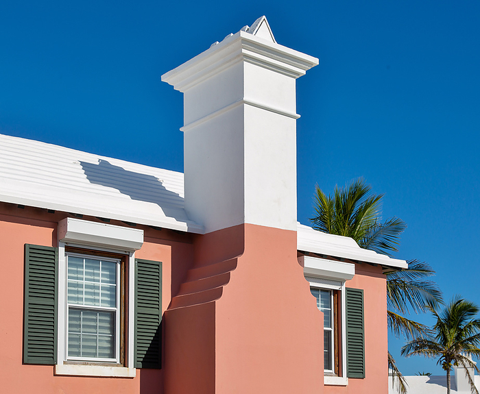 Typical Bermuda architecture, where the buildings are painted in pastel colours. The white stepped roof is designed to catch rainwater which is stored in tanks under the island s properties. Typical Bermuda architecture, building painted in pastel colours, with white stepped roof designed to catch rainwater for storage in underground tanks, Bermuda, North Atlantic, North America, by Barry Davis