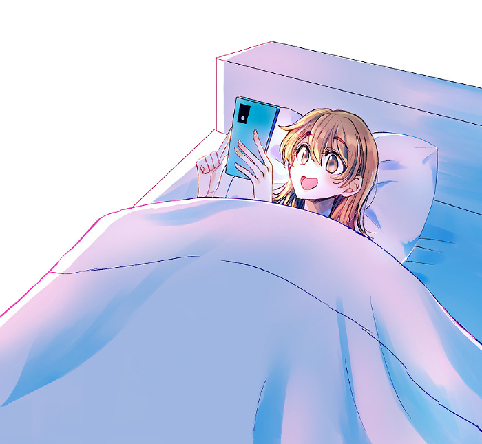 Woman laughing at her phone in bed