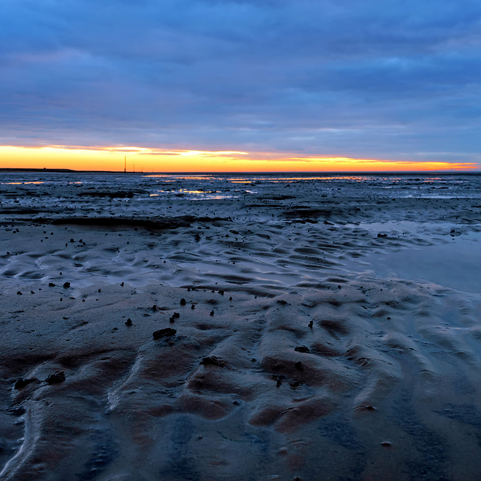 Sunset in the Lower Saxony Wadden Sea off Cuxhaven Sahlenburg at low tide, Germany Sunset in the Lower Saxony Wadden Sea off Cuxhaven Sahlenburg at low tide, Germany, by Zoonar Katrin May