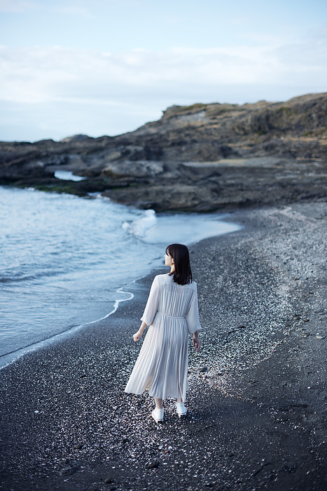Japanese woman walking on the beach