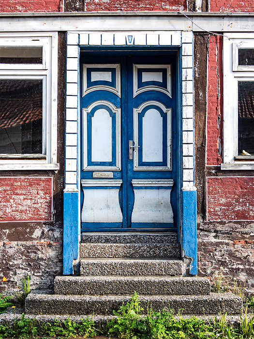 Old wooden door in blue and white color in a historic half timbered house Old wooden door in blue and white color in a historic half timbered house, by Zoonar Katrin May
