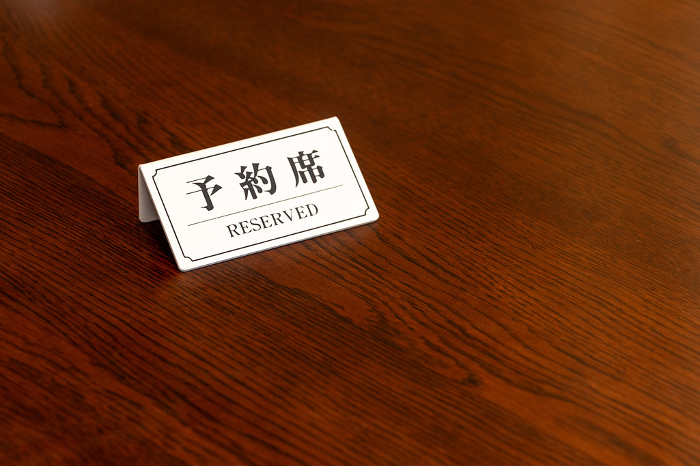 White tags indicating reserved seating on the table